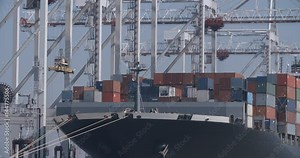 Container ship at Southampton Docks - 02 - A large container ship being loaded and unloaded with cargo at the docks in the UK port of Southampton. Shot in 4K on an FS7 camera.