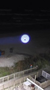 While vacationing at the beach, a group played with a flashlight one night. During the activity, someone mistook the beam for a police helicopter spotlight, causing brief confusion. The moment was captured on video, turning a casual evening into an amusing case of mistaken identity. | Jukin Copyright Management