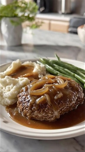 Old-Fashioned Hamburger Steak with Onion Gravy Ingredients: - 1.5 lb ground beef, 80 percent lean - 1 large yellow onion, thinly sliced - 1 large egg - 0.5 cup breadcrumbs - 2 tablespoons milk (or 2 tablespoons kefir as a probiotic alternative) - 2 tablespoons olive oil - 2 tablespoons butter - 2 cups beef stock - 2 tablespoons all-purpose flour - 1 teaspoon salt - 0.75 teaspoon black pepper - 0.5 teaspoon garlic powder - 0.5 teaspoon onion powder - 1 teaspoon Worcestershire-style seasoning alte