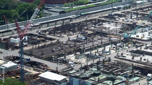 Large construction site with heavy construction machinery in metropolis captured during the early stage of mega construction project .
