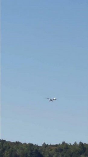 Viewing An Airplane Flying Over The Lake