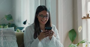 Phone, typing and funny woman in home living room for social media, scroll on app or email. Smartphone, happy and person with mobile meme, smile and laughing on internet, online networking and news