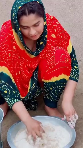 Kneading Dough in Traditional Attire: A Cultural Process