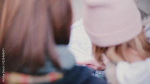 Close-up back view high angle shot of tourist man and woman looking at a city map travel guide together on a winter day. Stock Video