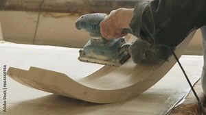 Close Up Of Carpentry Grinding Tool Removing Extra Wood On Detail Surface. Using Carpentry Grinding Tool To Finish Wooden Part. Carpentry Production. Grinding Tool For Woodwork Processing