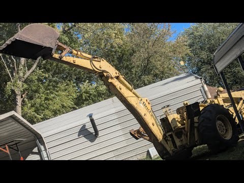 digging out a stump with the 4400 backhoe
