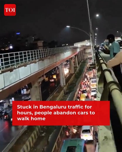1.4M views · 4.4K reactions | #Bengaluru | Thousands of people got off their company vehicles/buses and walked towards their homes on Wednesday night following a massive #traffic jam on and below the #ElectronicCity flyover after rains. People were stranded on the flyover for around 3 hours | The Times of India | Facebook