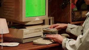 Retro PC with croma key green screen, Using vintage old computer. Dvd player, disc drive. Music recorder, playing retro computer games.