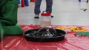 A large soap bubble inflates the presenter at the festival, uses special tools, liquid and a flat black basin. The presenter in a green suit shows children how giant soap bubbles are created