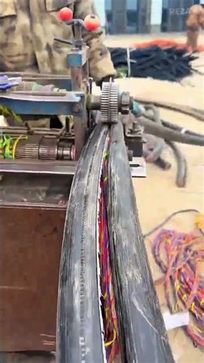 Operating a heavy duty wire stripping machine to remove thick rubber insulation from electrical