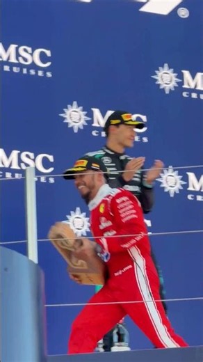 Lewis Hamilton celebrates his 106th Win in F1 with Ferrari on the podium