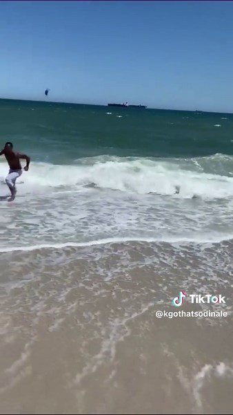 Beach Fun: Shirtless Man Enjoys Shoreline Activities