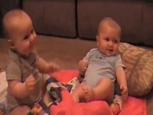 Funny baby Twins laughing so hard they fall over
