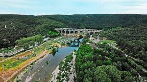 Aerial view of the aqueduct bridge with arched tiers in France. Drone view of Pont du Gard the highest Roman aqueduct bridge in the world.