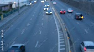 Downtown car traffic during the day time commuting to work and school. Soft focus of city traffic moving through the street. Blurred view of vehicle rush hour traffic.