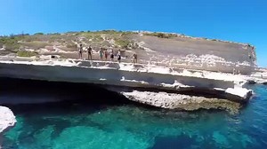 Now THAT's a doggy paddle! Watch as an adorable little terrier shows off with a brilliant dive into St Peter's Pool near Marsaxlokk | Bay Easy