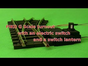 Piko G-Scale turnout with an electric switch and a lantern