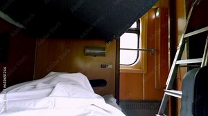 Sleep on the night train. Lie down shelf. The passenger is traveling. Recumbent seat compartment in the train Warsaw - Kyiv. View from inside Ukrainian high speed train.