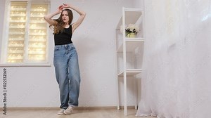 Young woman striking graceful dance poses in slow motion, showcasing elegance and artistic expression in a modern studio setting