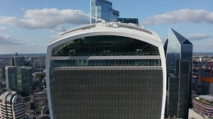 clip-1081790309-pull-back-shot-walkie-talkie-tall-building