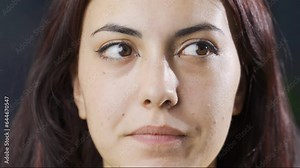 Close-up of sneaky woman's eyes averted.