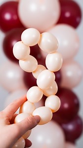 Balloon Pearls DIY! Turn 260 balloons into stunning pearls—just inflate, twist each section 5-7 times, and lock it in place! #balloontutorial #houseofpartyco #balloontips #balloontipsandtricks #pearlballoons | House of Party
