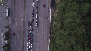 Top down aerial of cars lining up to board a ferry, numbered lanes, car traffic, queue, waiting, ferry terminal. 4K 24FPS