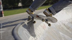 Cinematic slow motion shot of someone doing tricks and grinds in a mini ramp skatepark 4K