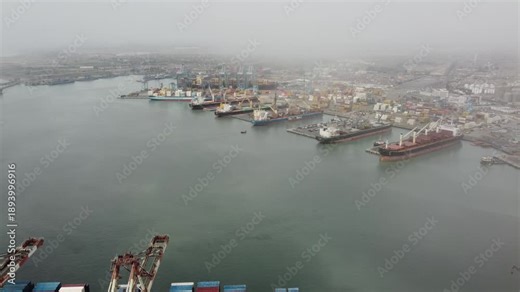 aerial Callao port panorama with fog expansive harbor with container stacks, gantry cranes, cargo