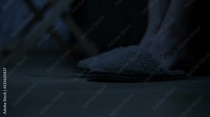 Close-up of female legs wearing slippers next to the bed in the bedroom. The effect of the American night. Cold toning. Night Stock Video