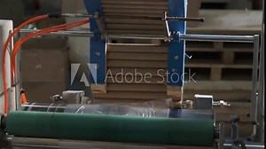 Factory production of polyethylene film, machine for packing food film, film is wound on cardboard blank, manufacturing process, automation conveyor, rotation of machine parts, environmentally harmful