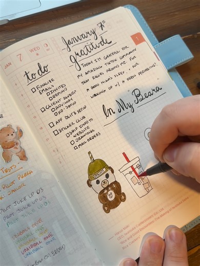 Entering my Bear-a 🐻☕️ Today's spread was about gratitude, sketching sticker ideas, and turning doodles into prototypes. February’s sticker club theme is officially underway: Bearistas, iced coffee, cozy café vibes. #journaling #stationerytok #stickerclub #hobonichi #comejournalwithme