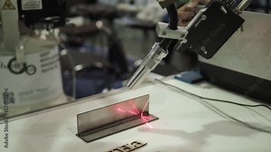 Industrial laser cutter. The programmed robot head cuts sheet of metal temperature. Modern machine improves quality and productivity.