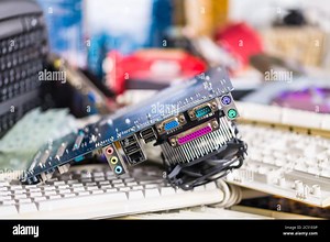Spare video card on pile of computer keyboards. Colored hardware parts. Mainboard with circuit board, connector sockets and cooler. Electronic waste Stock Photo - Alamy