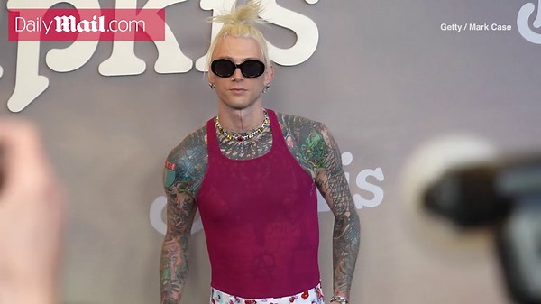 Machine Gun Kelly shows off his tats in a sleevless top at the 'Bupkis' premiere