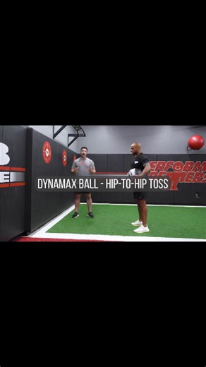 Hip-to-Hip Rotational Toss with the Dynamax Ball This movement teaches athletes to: ✔️ Load and explode from hip to hip ✔️ Improve rotational speed and control ✔️ Build power through the trunk and core Brett starts in an athletic stance, holding the medicine ball at his hip. As he rotates left or right, he pushes his feet into the ground and drives off of the leg he is rotating towards, exploding back towards his midline and driving the medicine ball into the wall, alternating sides with each re