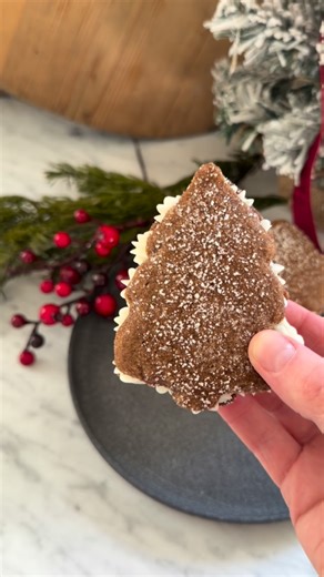 Kendra Thompson on Instagram: "These Molasses Tree Pies are everything I want in a holiday cookie and then some. Soft, spiced molasses cookies shaped like Christmas trees, sandwiched together with a thick, semi-sweet cream cheese frosting filling — basically moon pies, but richer, cozier, and way more festive. 🎄✨ They’re chewy, warmly spiced, slightly indulgent (okay… very indulgent), and absolutely perfect for a Christmas cookie exchange, holiday party, or cozy baking day at home. Slightly exc