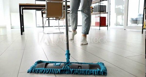 Cleaning lady mopping floor with microfiber cloth in office closeup 4k movie slow motion. House cleaning services concept
