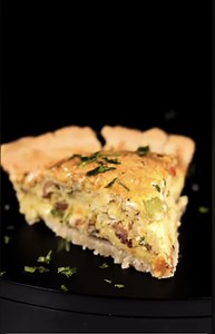 Freshly baked golden quiche reveals a rich, creamy filling that looks almost too good to slice