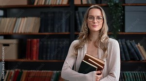 Portrait smiling librarian teacher science professor woman hold books stack posing at library