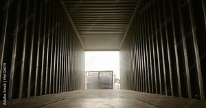 Forklift lifting up a cargo inside container view closing up