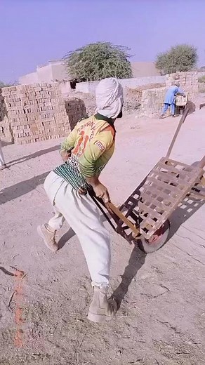 Moving a Wooden Wheelbarrow in Rural Setting