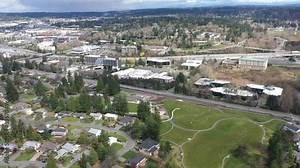 Aerial / drone footage of abandoned streets, a park without people downtown and in the commercial, business district of Belleview near Seattle, Washington