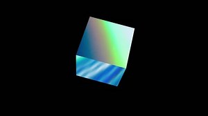 Rotating cube with holographic reflection. 3D animation on a black background.