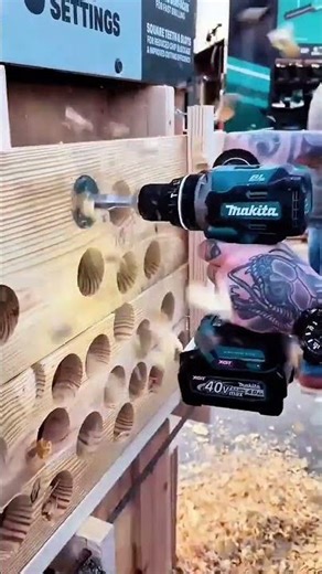 High-power cordless drill makes quick and clean holes in a thick wooden block