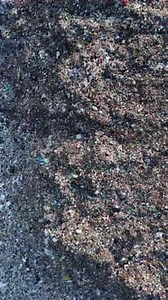 Abstract Footage of Industrial Waste Material Piled Up High Above