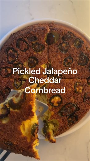 Pickled Jalapeño Cheddar Cornbread I was curious if I could adaptmy favorite Honey Cornbread Recipe to remove the sweetness and add in pickled jalapeños and cheddar, and I am so happy with how it came out!! INGREDIENTS 2 boxes of Jiffy cornbread mix 2 eggs 2/3 cup milk (I only had heavy cream today) 2 large handfuls of shredded cheddar 1/4 cup oil 2/3 cup sour cream 1 tbsp salted butter Pickled jalapeños DIRECTIONS 1. Preheat oven to 400 degrees. 2. Melt 1 tbsp of butter in cast iron in oven whi