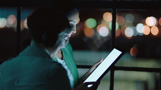 Business team working late colleagues using tablet computer brainstorming ideas for project deadline manager woman sharing strategy meeting in office at night | Premium Stock Video Footage