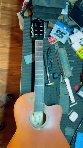 Fret leveling and complete setup for a Michael nylon string acoustic guitar.