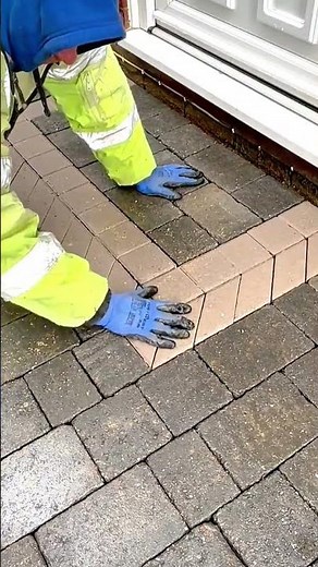 Installing sloped brick edging for outdoor pathway drainage